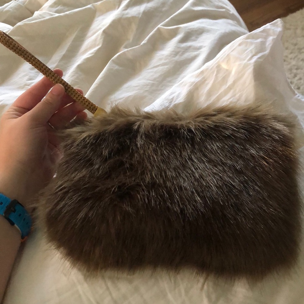 Faux fur clutch with rhinestone strap
